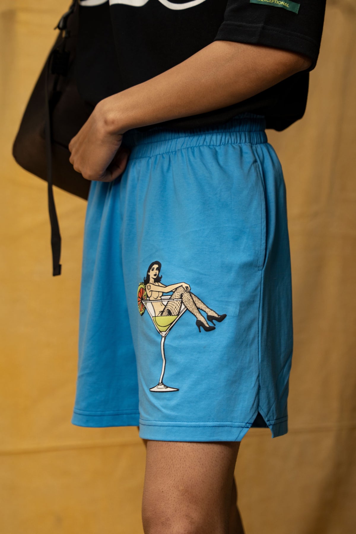 The Dirty Martini Lounge Shorts (Unisex): side view of the blue shorts with martini-glass graphic