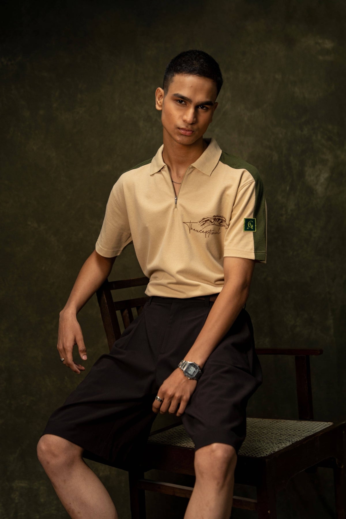 Slither Classic Polo (Unisex): model wearing the beige polo, seated front view