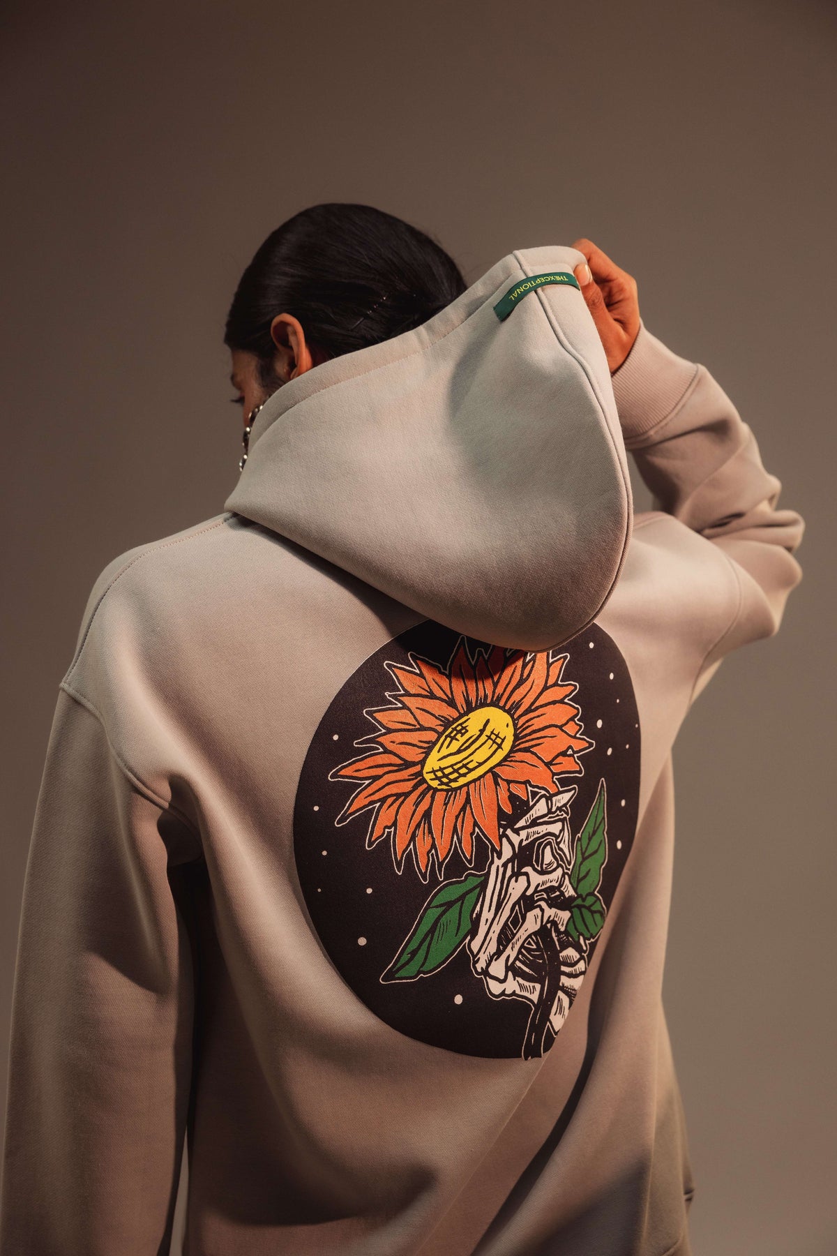 AG Sunflare Reaper (Unisex): close-up of the flower and skull back graphic on a model