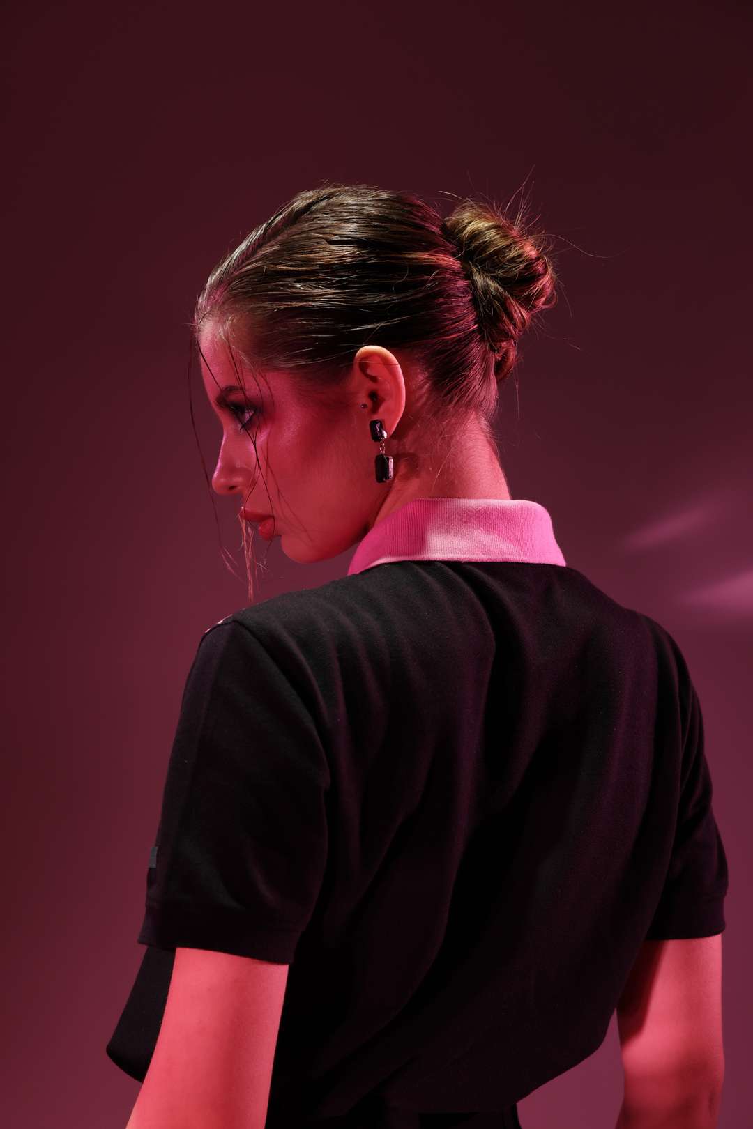 Pink Diamond Classic Polo: model wearing the black polo, back view