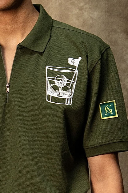 The 18th Hole Classic Polo (Unisex): close-up of the golf chest graphic and sleeve patch
