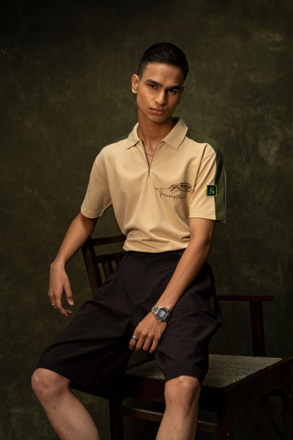 Slither Classic Polo (Unisex): model wearing the beige polo, seated front view