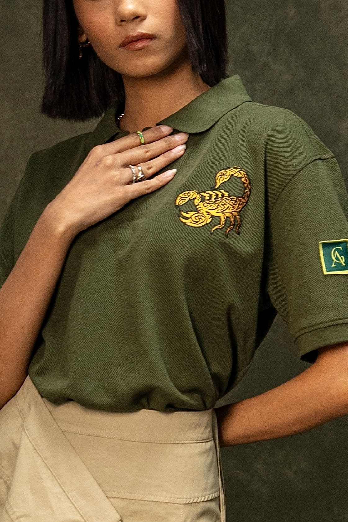 Death Sting Classic Polo (Unisex): close-up of the gold scorpion chest graphic