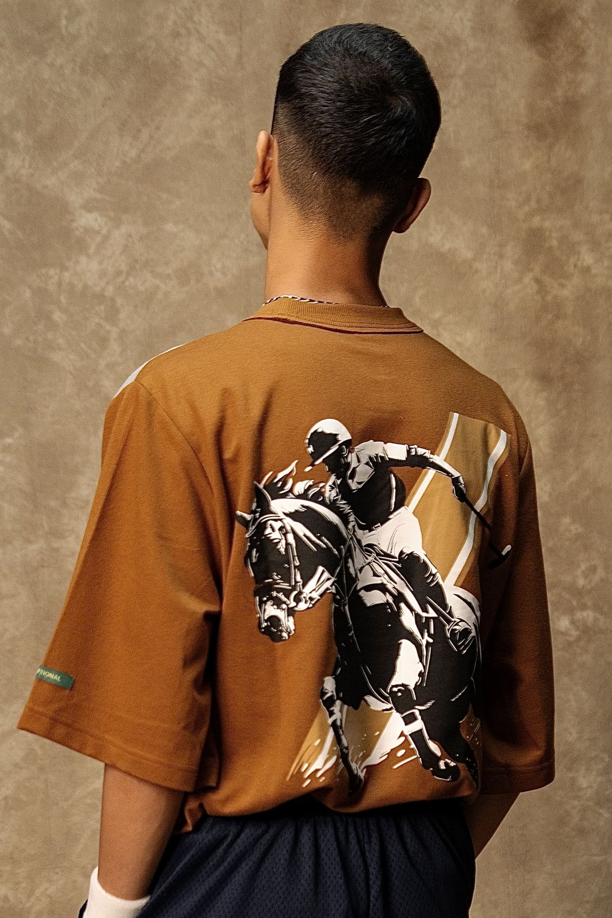 Chukker Charge Lounge T-shirt (Unisex): model wearing the brown T-shirt, full back view