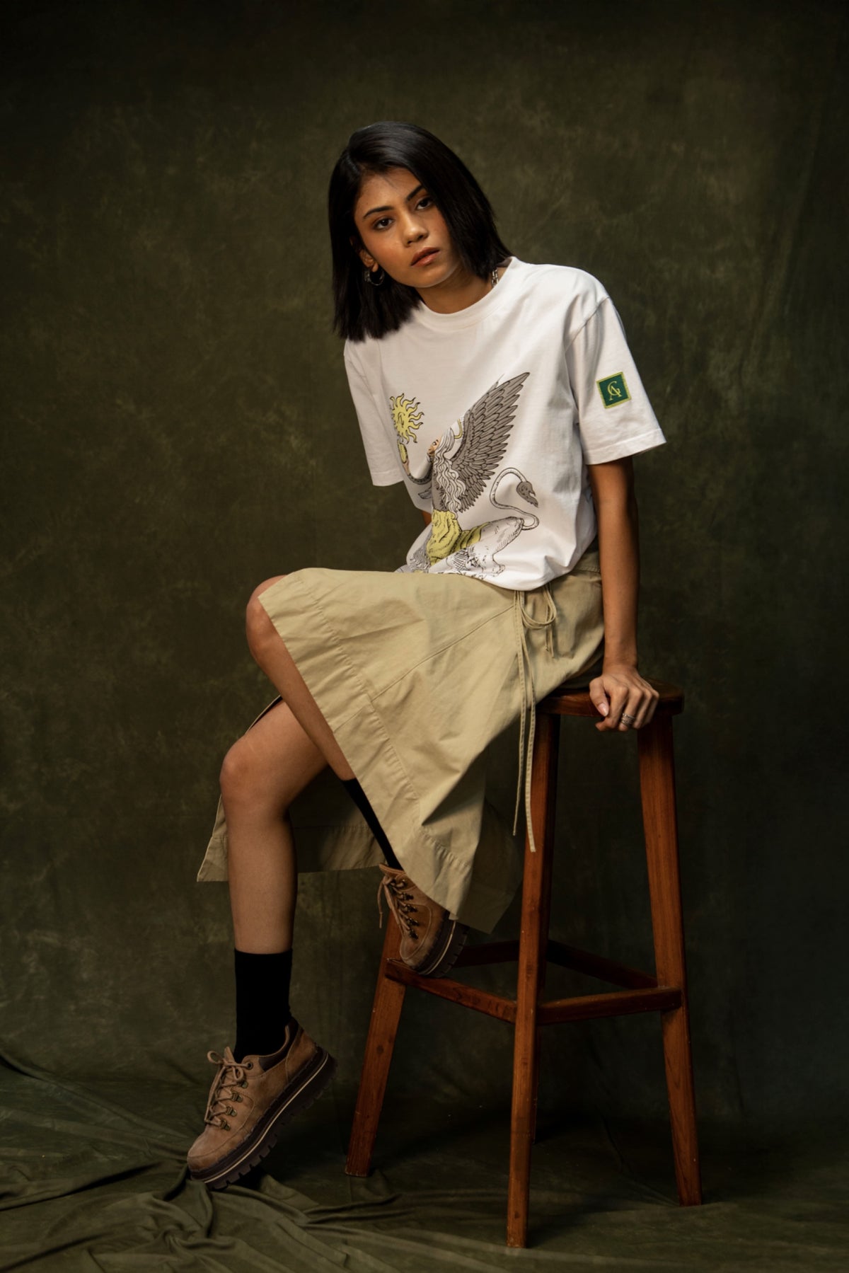 Yellow Apple Classic T-shirt (Unisex): model wearing the white T-shirt, seated front view