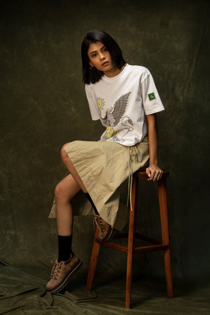 Yellow Apple Classic T-shirt (Unisex): model wearing the white T-shirt, seated front view