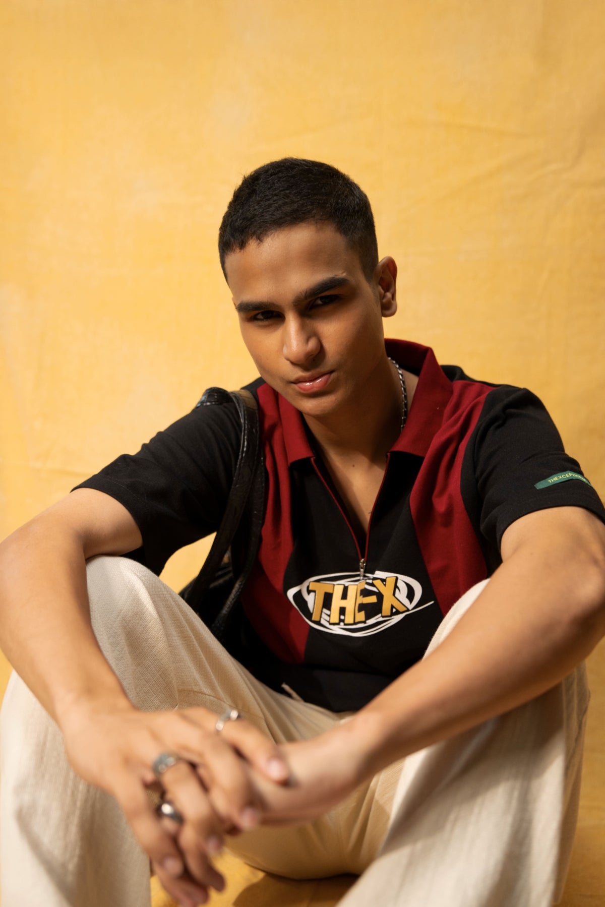 Drunk Freaks Lounge Polo (Unisex): model wearing the striped polo, seated front view