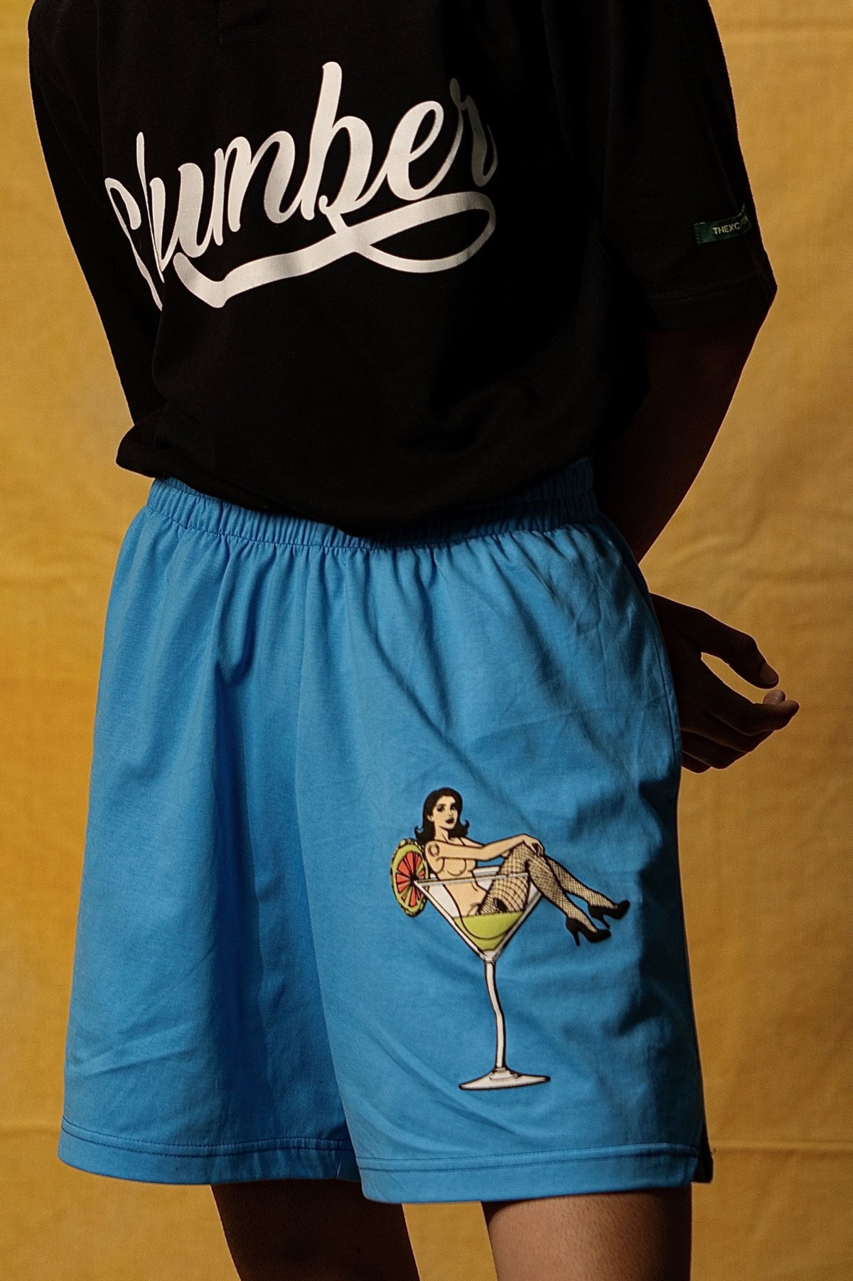 The Dirty Martini Lounge Shorts (Unisex): front view of the blue shorts on a model