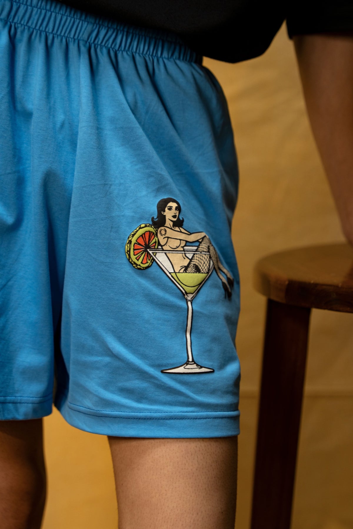 The Dirty Martini Lounge Shorts (Unisex): close-up of the martini-glass leg graphic