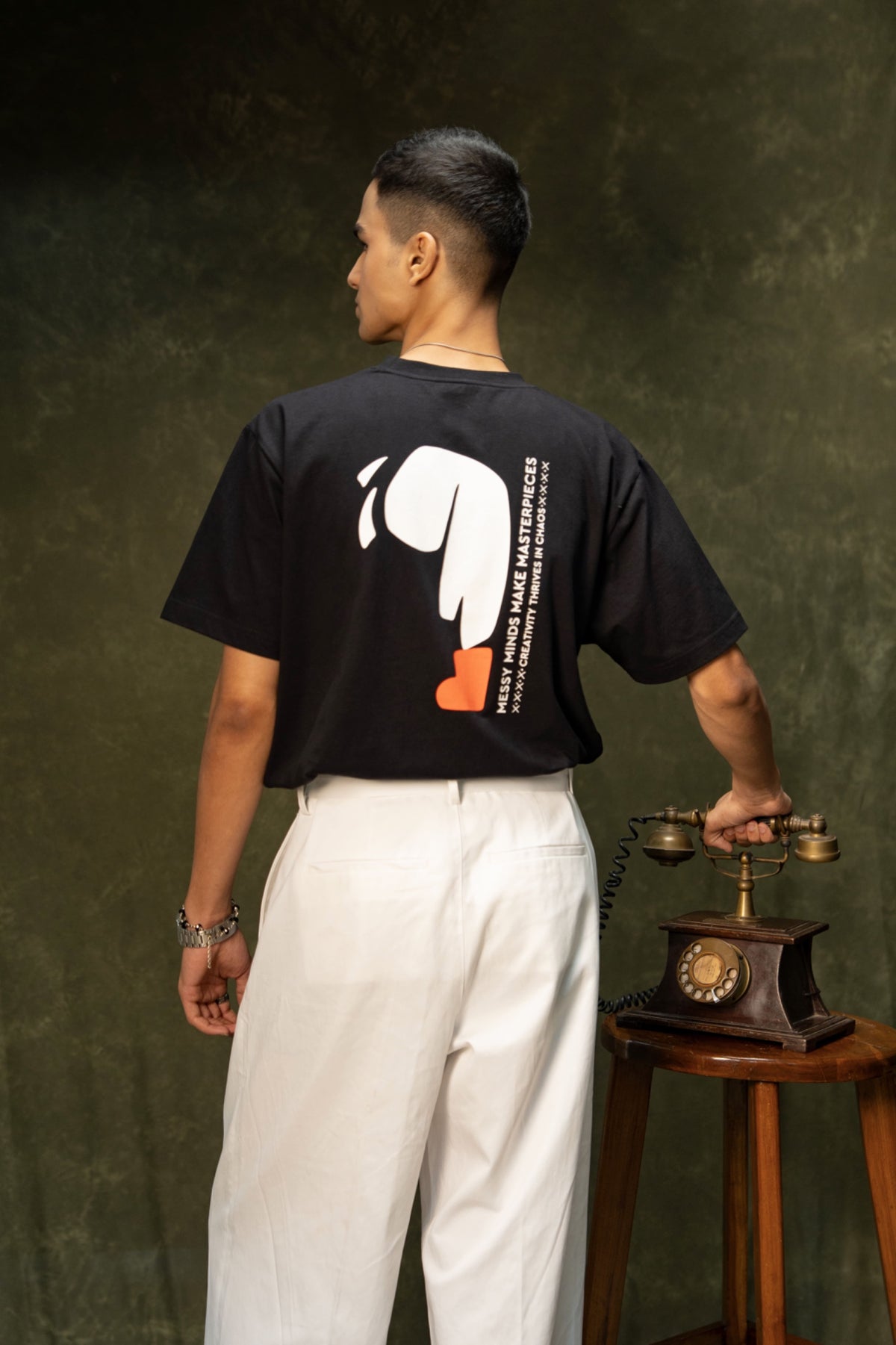 Messy Minds Classic T-shirt (Unisex): model wearing the black T-shirt, back view