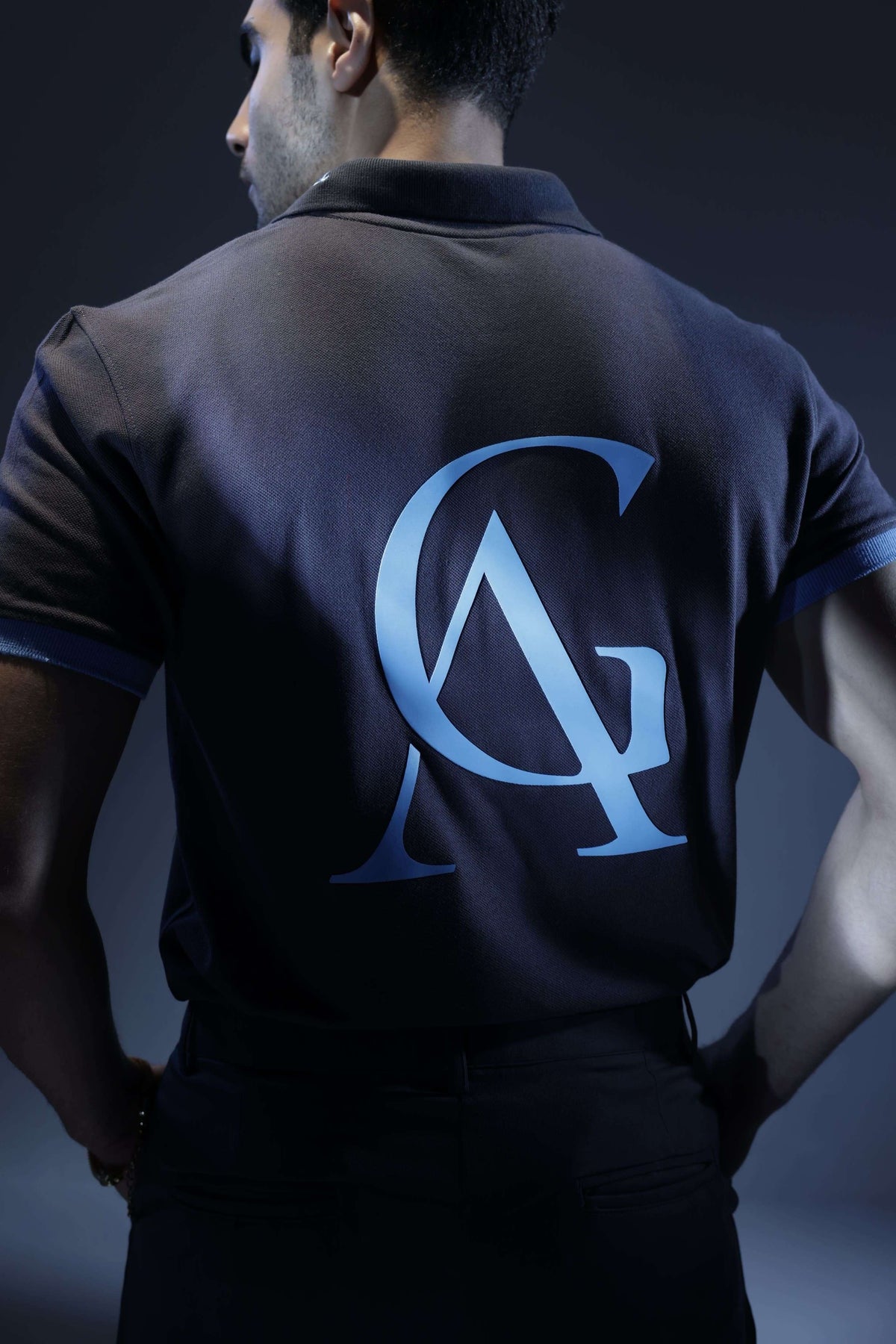 Ash Sky Classic Polo (Unisex): back view on a model showing the blue AG monogram