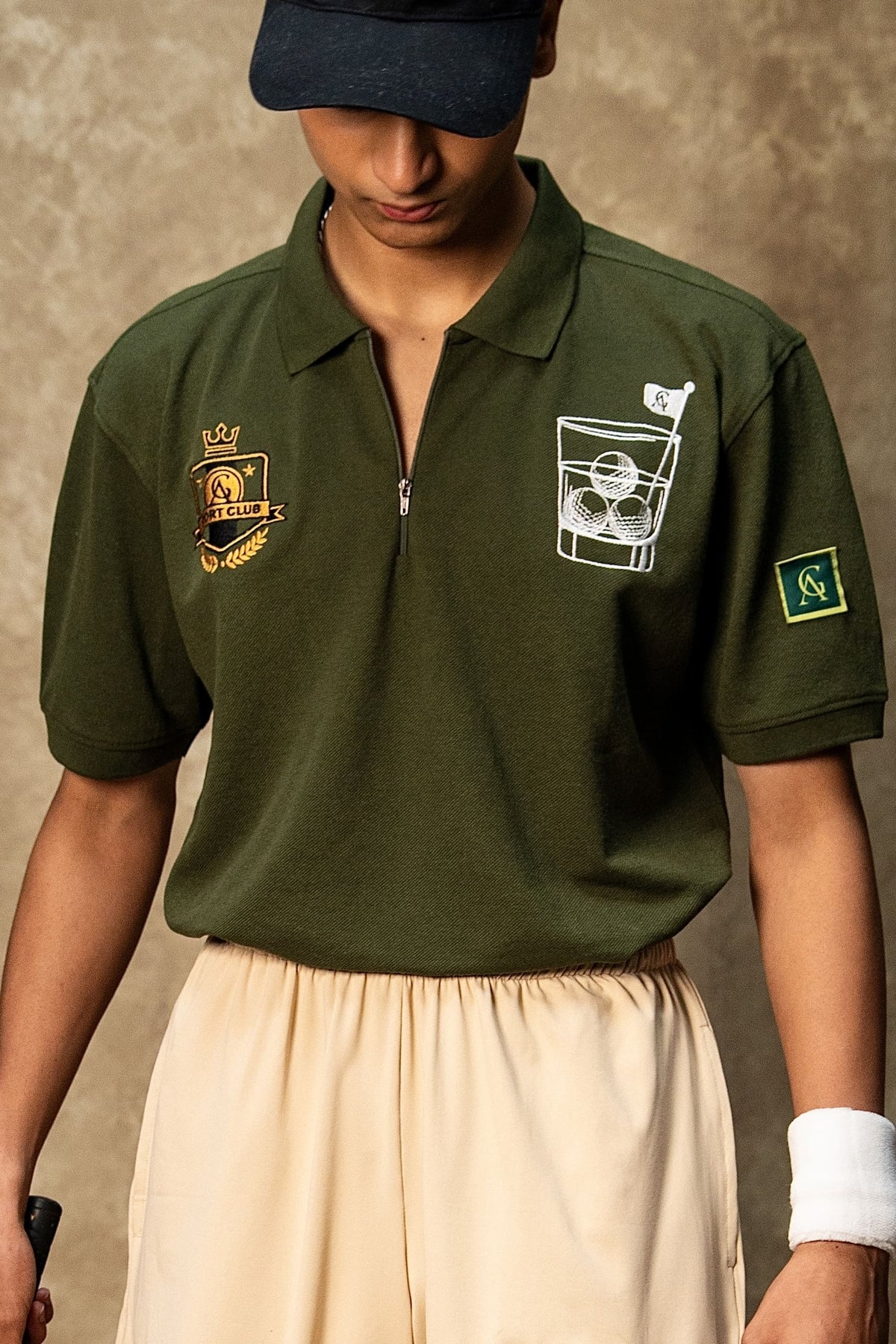 The 18th Hole Classic Polo (Unisex): model wearing the olive green polo, front view