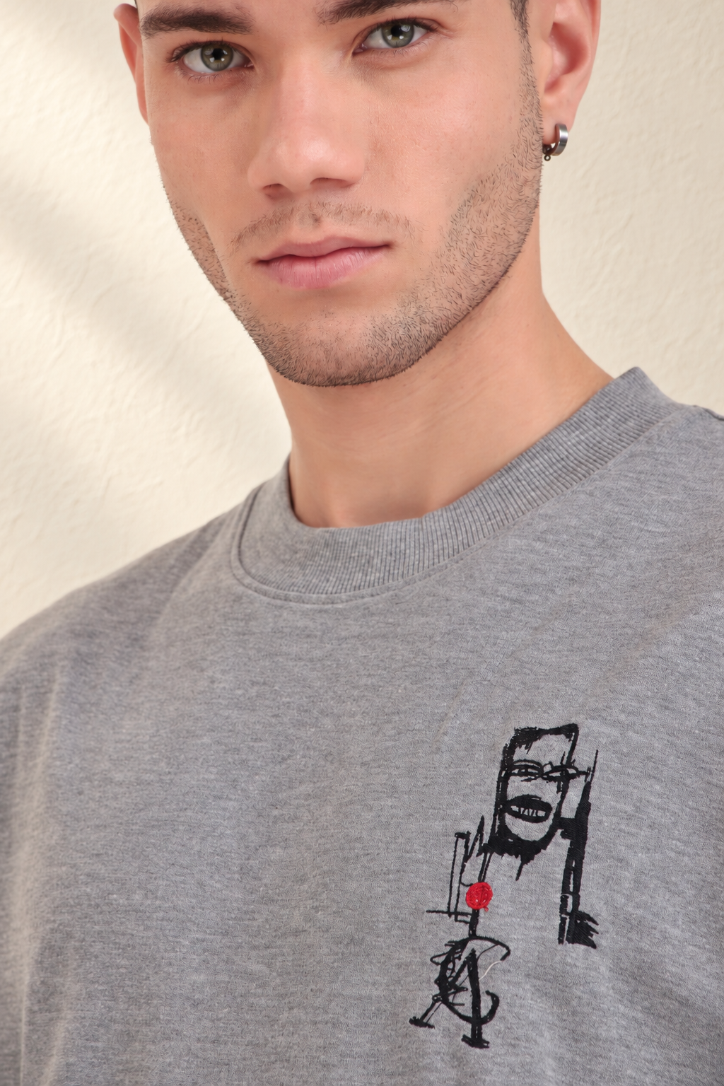 Tribal Masks Lounge T-Shirt: close-up of the grey T-shirt and chest mask graphic