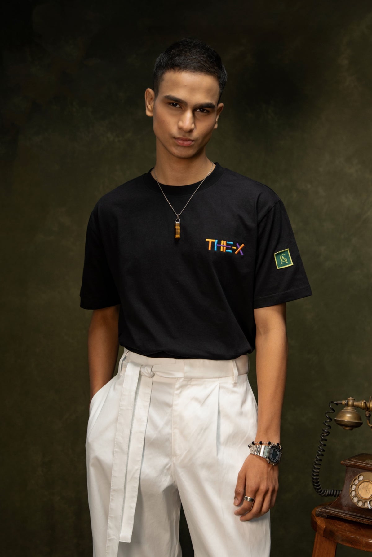 Messy Minds Classic T-shirt (Unisex): model wearing the black T-shirt with white trousers