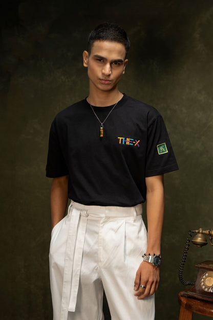 Messy Minds Classic T-shirt (Unisex): model wearing the black T-shirt with white trousers