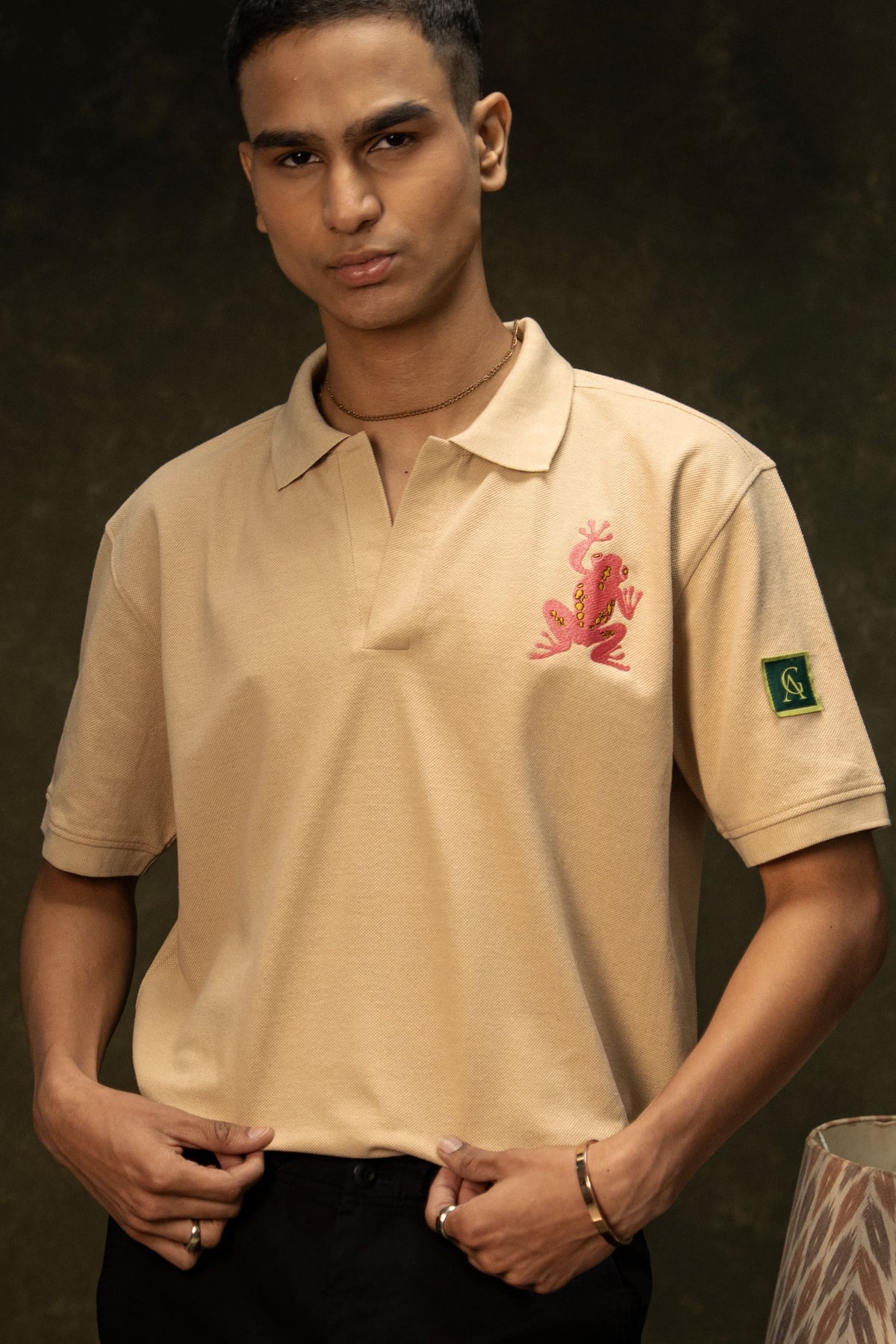 Pink Poison Classic Polo (Unisex): model wearing the beige polo, front view
