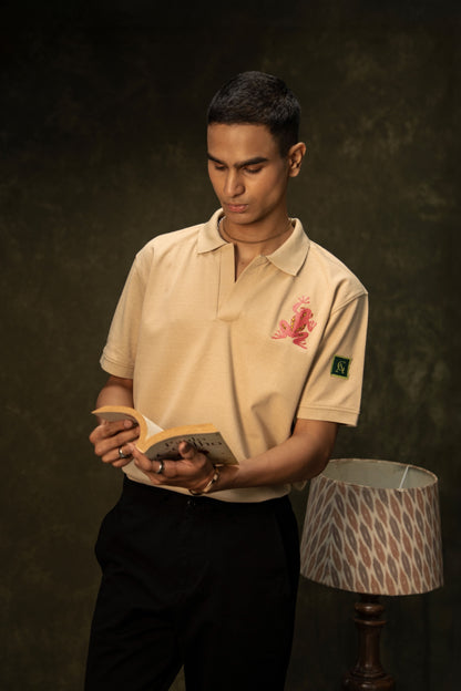 Pink Poison Classic Polo (Unisex): model wearing the beige polo holding a book